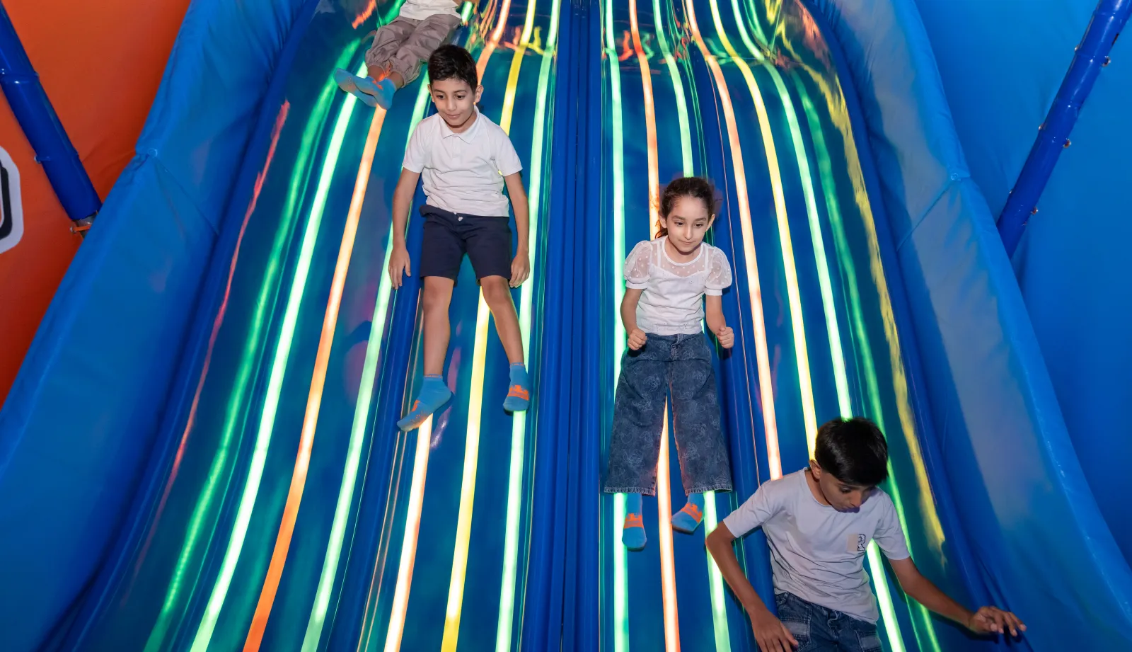 Children sliding at Trampo Oman